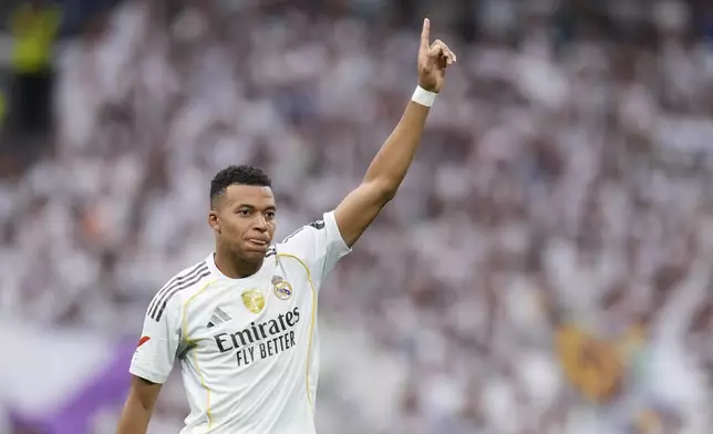 Real Madrid's Kylian Mbappe celebrates after scoring his side's second goal during the Spanish La Liga soccer match between Real Madrid and Espanyol at the Santiago Bernabeu stadium in Madrid, Spain, Saturday, Sept. 20, 2025. (AP Photo/Manu Fernandez)