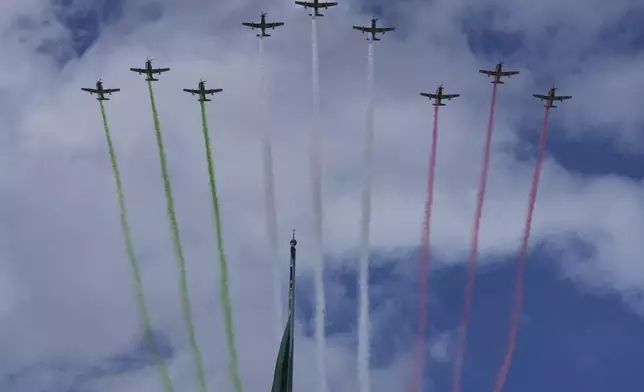 Planes fly with contrails of the colors of Mexico's flag during the annual Independence Day military parade in Mexico City, Tuesday, Sept. 16, 2025. (AP Photo/Fernando Llano)