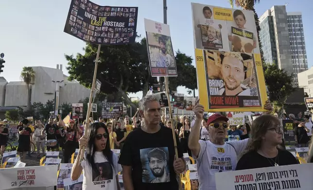 Relatives and supporters of hostages held by Hamas in the Gaza Strip take part in a protest demanding their immediate release and against the Israeli offensive in Gaza City, as they gather in Tel Aviv, Sunday, Aug. 31, 2025. (AP Photo/Mahmoud Illean)
