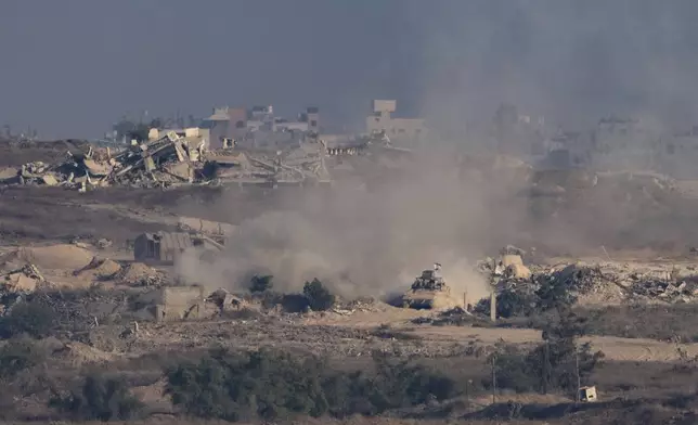 An Israeli armored vehicle moves in an area in the Gaza Strip, as seen from southern Israel, Sunday, Aug. 31, 2025. (AP Photo/Maya Levin)