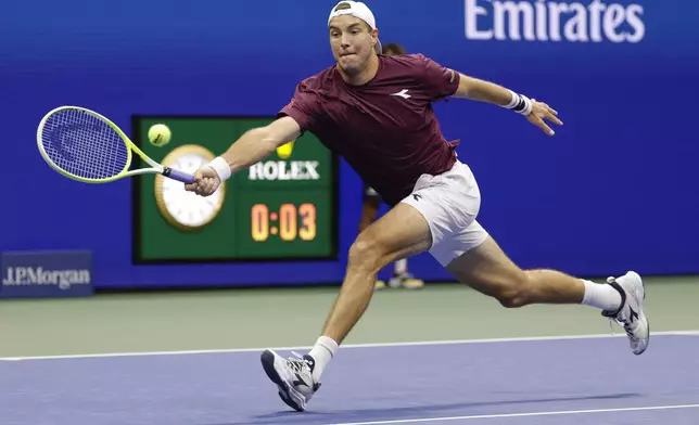 Jan-Lennard Struff, of Germany, returns a shot to Novak Djokovic, of Serbia, during the fourth round of the U.S. Open tennis championships, Sunday, Aug. 31, 2025, in New York. (AP Photo/Adam Hunger)