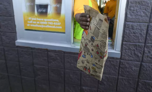 FILE - A McDonald's order is delivered on the drive-thru window Tuesday, Aug. 5, 2025, in Arlington, Texas. (AP Photo/Julio Cortez, File)
