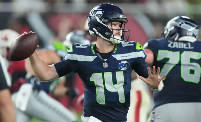 Seattle Seahawks quarterback Sam Darnold (14) throws during the second half of an NFL football game against the Arizona Cardinals Thursday, Sept. 25, 2025, in Glendale, Ariz. (AP Photo/Ross D. Franklin)