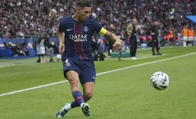 PSG's Achraf Hakimi plays the ball during the French League One soccer match between Paris Saint-Germain and Lens at the Parc des Princes stadium in Paris, Sunday, Sept. 14, 2025. (AP Photo/Michel Euler)