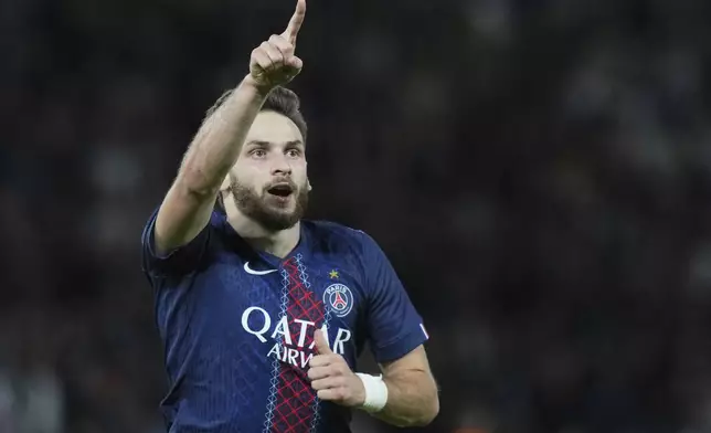 PSG's Khvicha Kvaratskhelia celebrates after scoring his side's second goal during the Champions League opening phase soccer match between Paris Saint-Germain and Atalanta at the Parc des Princes stadium in Paris, France, Wednesday, Sept. 17, 2025. (AP Photo/Thibault Camus)