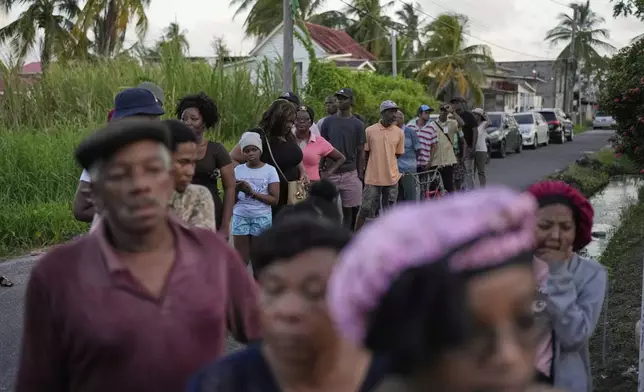 Voters line up at a polling station during general elections in Georgetown, Guyana, Monday, Sept. 1, 2025. (AP Photo/Matias Delacroix)