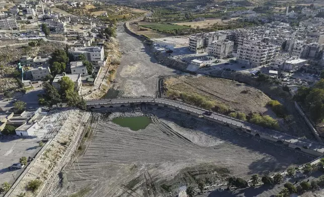 A drone view shows the dried up Orontes River in Jisr al-Shughur, west of Idlib, Syria, on Aug. 14, 2025. (AP Photo/Omar Albam)