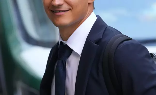 IndyCar champion Alex Palou arrives at court at the start of a breach of contract lawsuit with McLaren Racing, in London, Monday, Sept. 29, 2025. (AP Photo/Kirsty Wigglesworth)