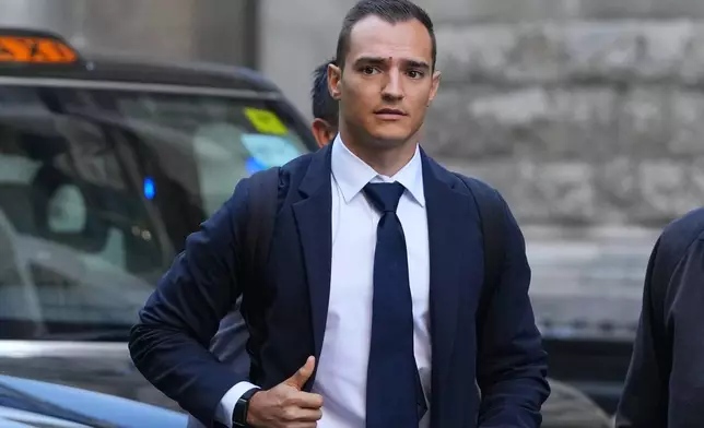 IndyCar champion Alex Palou arrives at court at the start of a breach of contract lawsuit with McLaren Racing, in London, Monday, Sept. 29, 2025. (AP Photo/Kirsty Wigglesworth)