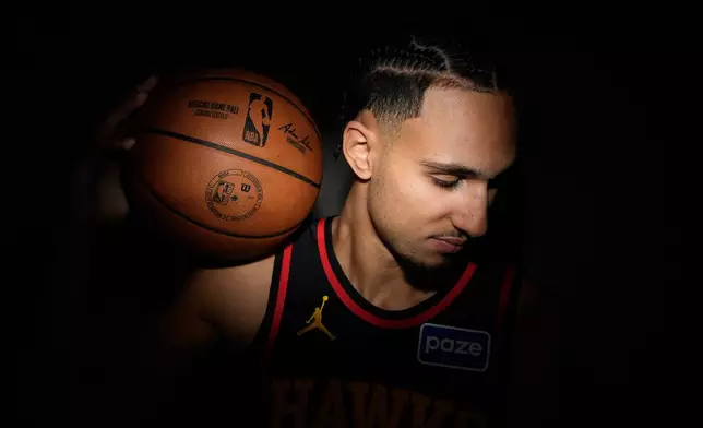 Atlanta Hawks' Zaccharie Risacher (10) poses for a photograph during an NBA basketball media day on Monday, Sept. 29, 2025, in Atlanta. (AP Photo/Brynn Anderson)