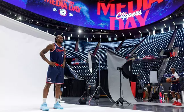 Los Angeles Clippers forward Kawhi Leonard (2) and guard Chris Paul (3) pose during the NBA basketball team's media day Monday, Sept. 29, 2025, in Inglewood, Calif. (AP Photo/Eric Thayer)