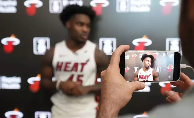 Miami Heat guard Davion Mitchell answers questions during the NBA basketball team's media day, Monday, Sept. 29, 2025, in Miami. (AP Photo/Jim Rassol)
