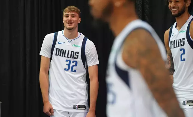 Dallas Mavericks forward Cooper Flagg (32) laughs with center Dereck Lively II (2) and other teammates during the NBA basketball team's media day in Dallas, Monday, Sept. 29, 2025. (AP Photo/LM Otero)