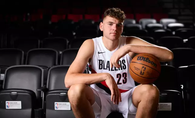 Portland Trail Blazers center Donovan Clingan poses for photos during the NBA basketball team's media day in Portland, Ore., Monday, Sept. 29, 2025. (AP Photo/Craig Mitchelldyer)