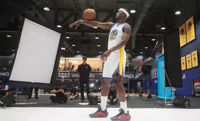 Golden State Warriors forward Jimmy Butler III poses for photos during the NBA basketball team's media day in San Francisco, Monday, Sept. 29, 2025. (AP Photo/Jeff Chiu)