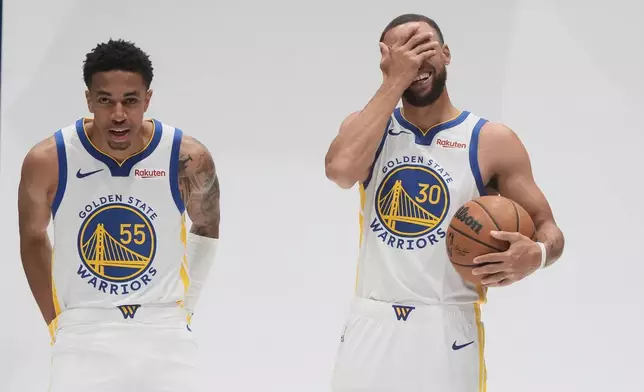 Golden State Warriors guard Stephen Curry (30) reacts while posing for photos with Chance McMillian (55) during the NBA basketball team's media day in San Francisco, Monday, Sept. 29, 2025. (AP Photo/Jeff Chiu)