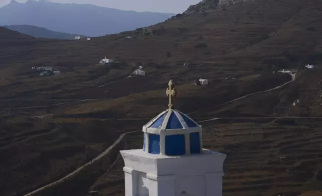 Family-owned chapels stand on the Aegean Sea island of Tinos, Greece, Sunday, Sept. 7, 2025. (AP Photo/Petros Giannakouris)