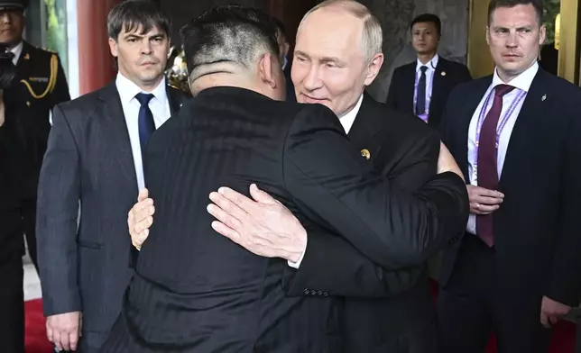 Russian President Vladimir Putin, center right, and North Korean leader Kim Jong Un hug each other after their meeting at Diaoyutai State Guesthouse in Beijing, China, Wednesday, Sept. 3, 2025. (Sergei Bobylev, Sputnik, Kremlin Pool Photo via AP)