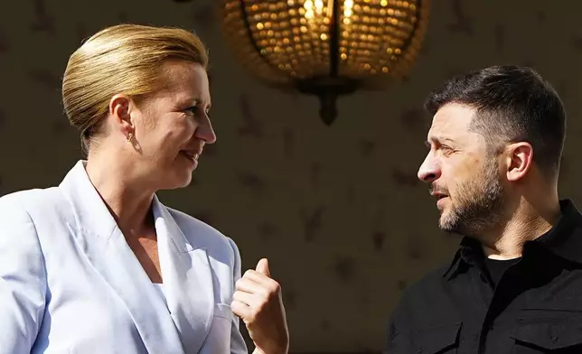 Danish Prime Minister Mette Frederiksen, left, welcomes Ukraine's President Volodymyr Zelenskyy, on the lawn in front of Marienborg, in Copenhagen, Wednesday, Sept. 3, 2025. (Mads Claus Rasmussen/Ritzau Scanpix via AP)