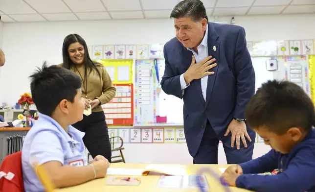 Gov. J.B. Pritzker speaks with kindergarten student at Prairie Oak Elementary School at 1427 Oak Park Ave. in Berwyn, Thursday, Sept. 4, 2025. (Anthony Vazquez/Chicago Sun-Times via AP, Pool)