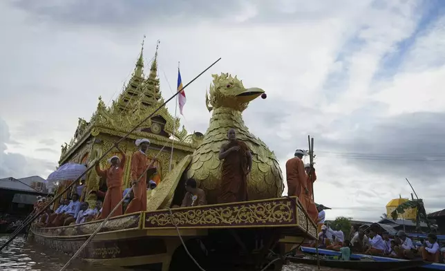 A huge barge carrying Buddha statues floats during the Phaung Daw Oo pagoda festival in Inle Lake, southern Shan State, Myanmar, Tuesday, Sept. 23, 2025. (AP Photo/Thein Zaw)