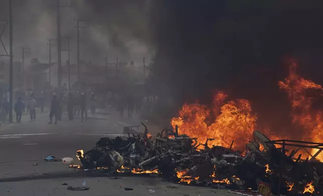 Protesters burn vehicles and tires during protests against social media ban and corruption in Kathmandu, Nepal, Tuesday, Sept. 9, 2025. (AP Photo/Niranjan Shrestha)