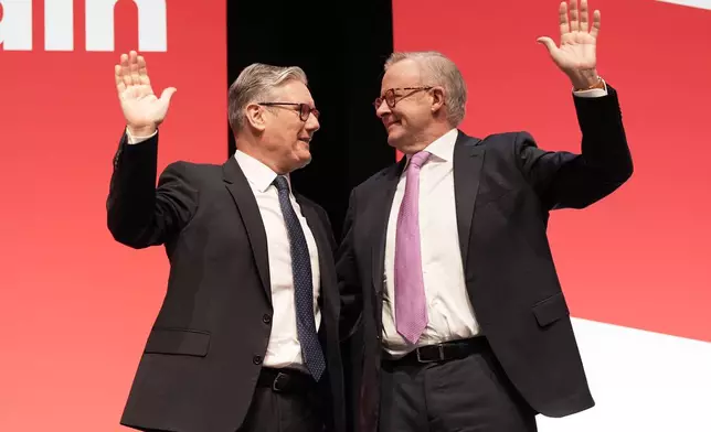 Britain's Prime Minister Keir Starmer and Australian Prime Minister Anthony Albanese, right, attend the Labour Party Conference in Liverpool, England, Sunday Sept. 28, 2025. (Stefan Rousseau/PA via AP)