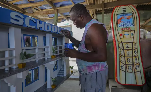 Joseph Adjetey works on a fantasy coffin at Eric Kpakpo's carpentry shop in La, Accra, Ghana, Wednesday, July 23, 2025. (AP Photo/Misper Apawu)