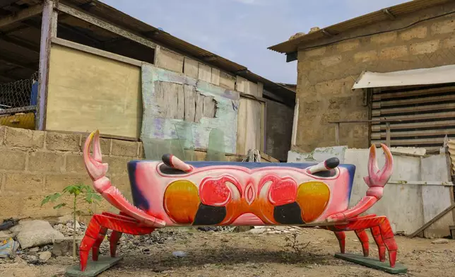 A crab fantasy coffin crafted by Eric Kpakpo Adotey is displayed by his shop in La, Accra, Ghana, Friday, July 25, 2025. (AP Photo/Misper Apawu)