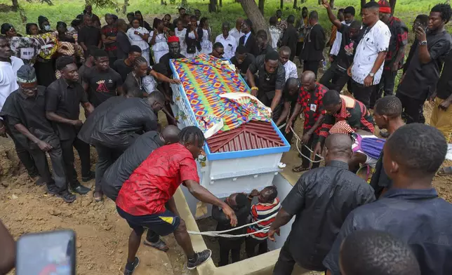 The fantasy coffin of the late Robert Nii Anang Obodai, a former school proprietor, is lowered into his grave in Accra, Ghana, Saturday, July 26, 2025. (AP Photo/Misper Apawu)