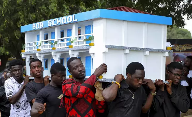 Men carry the fantasy coffin of the late Robert Nii Anang Obodai, a former school proprietor, during his funeral, in Accra, Ghana, Saturday, July 26, 2025. (AP Photo/Misper Apawu)