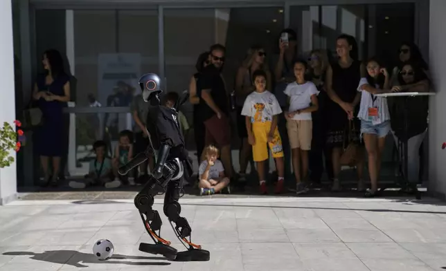 The Booster T1 robot plays soccer at the first International Humanoid Olympiad at the Olympic Academy, in ancient Olympia, Greece, Monday, Sept. 1, 2025. (AP Photo/Thanassis Stavrakis)