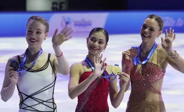 Gold medalist Adeliia Petrosian of Russia, competing as a neutral athlete, centre, poses with silver medalist Anastasiia Gubanova of Georgia, left, and bronze medalist Loena Hendrickx of Belgian, right, after competing in Women free skating at the ISU Skate to Milano figure skating qualifier 2025, in Beijing, China, Saturday, Sept. 20, 2025. (AP Photo/Mahesh Kumar A.)