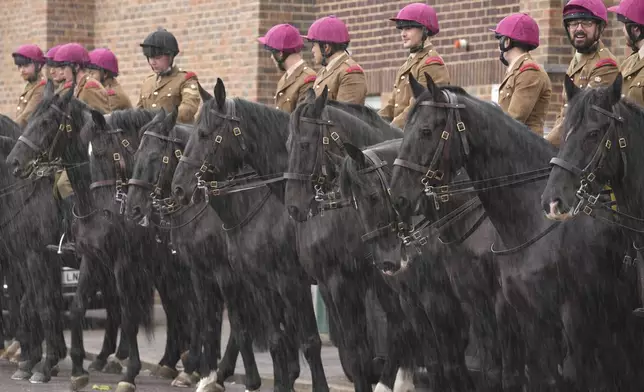 Soldiers of Household Cavalry Mounted Regiment rehearse at preparations for the carriage procession at Combermere Barracks, in Windsor, England, Monday, Sept. 15, 2025, ahead of the state visit of U.S. President Donald Trump. (AP Photo/Kin Cheung)