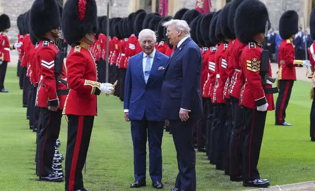 President Donald Trump and Britain's King Charles III review the Guard of Honour after the arrival at Windsor Castle in Windsor, England, Wednesday, Sept. 17, 2025.(AP Photo/Kirsty Wigglesworth, Pool)