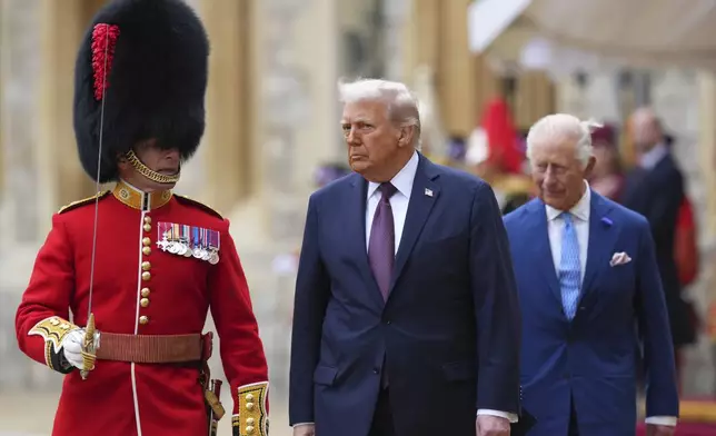 President Donald Trump and Britain's King Charles III review the Guard of Honour after the arrival at Windsor Castle in Windsor, England, Wednesday, Sept. 17, 2025.(AP Photo/Kirsty Wigglesworth, Pool)