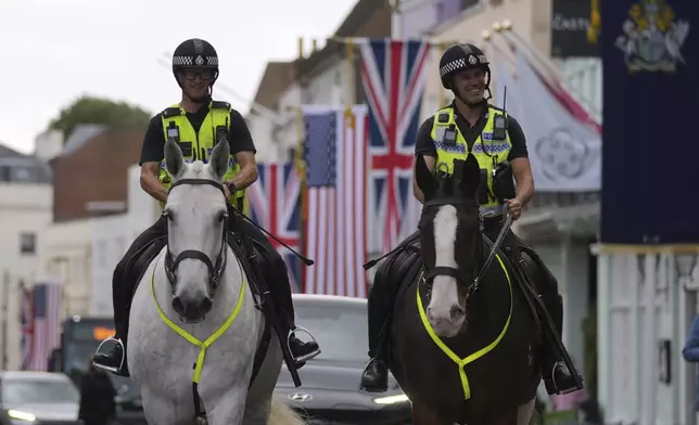 Police officers patrol outside the Windsor Castle in Windsor, England, Monday, Sept. 15, 2025, ahead of the state visit of U.S. President Donald Trump. (AP Photo/Kin Cheung)