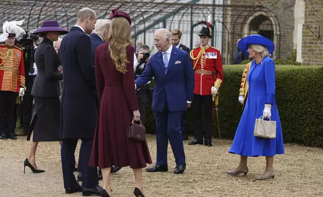 Britain's King Charles III and Queen Camilla, right, receive President Donald Trump and first lady Melania Trump as Prince William and Kate, Princess of Wales look on, as they arrive at Windsor Castle in Windsor, England, Wednesday Sept. 17, 2025. (Aaron Chown/Pool Photo via AP)