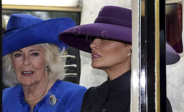 Britain's Queen Camilla and First lady Melania Trump sit in a carriage during a procession through Windsor Castle, in Windsor, England, Wednesday, Sept. 17, 2025. (Toby Melville/Pool Photo via AP)