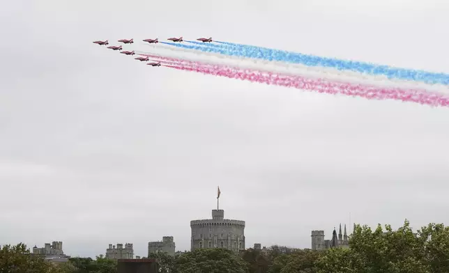 The Red Arrows fly in formation over Windsor Castle during the State visit of President Donald Trump in Windsor, England, Wednesday, Sept. 17, 2025.(AP Photo/Alastair Grant)