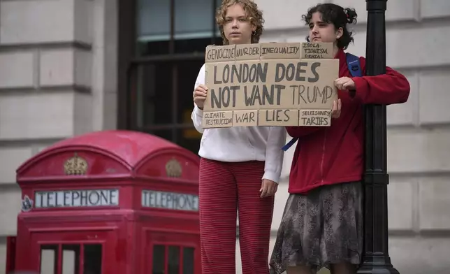 Protesters hold a placard during a demonstration of the Stop Trump Coalition group against President Donald Trump's state visit in London, Wednesday, Sept. 17, 2025.(AP Photo/Kin Cheung)