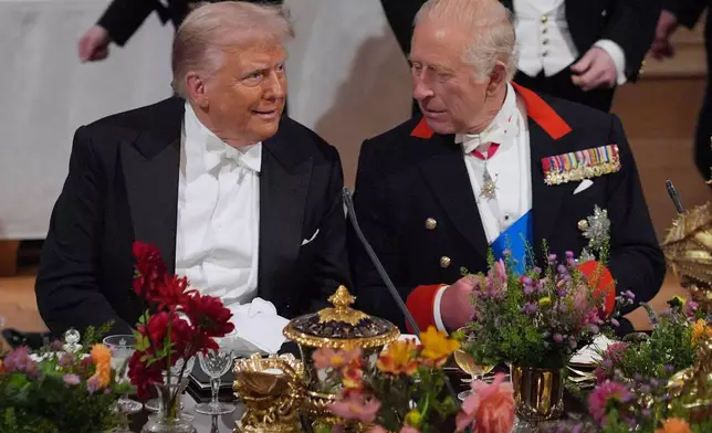 Britain's King Charles, right, and U.S. President Donald Trump speak at a State Banquet in Windsor Castle, England, on day one of U.S. President Donald Trump and First Lady Melania Trump's second state visit to the UK, Wednesday Sept. 17, 2025. (Yui Mok/PA via AP, Pool Photo via AP)