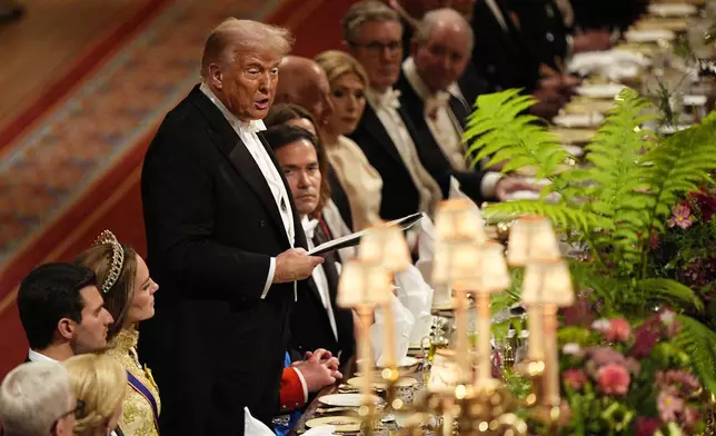 U.S. President Donald Trump, fourth left, listens as Britain's King Charles gives a speech during the State Banquet in Windsor Castle, England, on day one of U.S. President Donald Trump and First Lady Melania Trump's second state visit to the UK, Wednesday Sept. 17, 2025. (Aaron Chown/PA via AP, Pool Photo via AP)