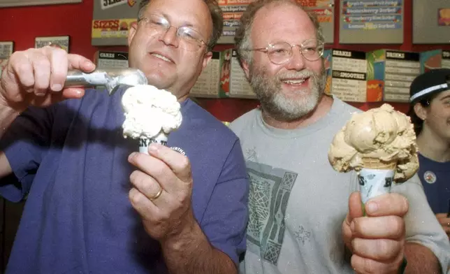 FILE - Jerry Greenfield, left, and Ben Cohen scoop ice cream cones during their 20th anniversary party at a scoop shop in Burlington, Vt., in this May 5, 1998 photo. (AP Photo/Toby Talbot, File)