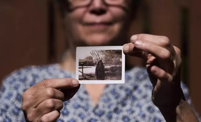 Valerie Nagle, whose DNA recently helped to confirm the remains of her sister Marion Vinetta Nagle McWhorter, who disappeared in 1974 in Oregon, poses for a portrait with a photo of her sister Thursday, Sept. 18, 2025, in Seattle. (AP Photo/Lindsey Wasson)