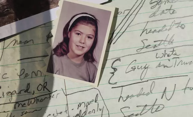 A school photo of Marion Vinetta Nagle McWhorter, who disappeared in 1974 in Oregon and whose remains were recently confirmed by DNA from her sister Valerie Nagle, is seen over notes taken by Nagle about McWhorter's disappearance Thursday, Sept. 18, 2025, in Seattle. (AP Photo/Lindsey Wasson)