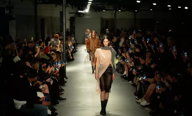 Models wear creations part of the N21 women's Spring-Summer 2026 collection, that was presented in Milan, Italy, Wednesday, Sept. 24, 2025. (AP Photo/Luca Bruno).