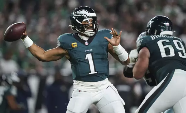 Philadelphia Eagles quarterback Jalen Hurts (1) throws a pass in the first half of an NFL football game against the Dallas Cowboys Thursday, Sept. 4, 2025, in Philadelphia. (AP Photo/Matt Slocum)
