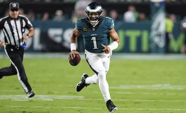 Philadelphia Eagles quarterback Jalen Hurts (1) runs the ball in the first half of an NFL football game against the Dallas Cowboys Thursday, Sept. 4, 2025, in Philadelphia. (AP Photo/Chris Szagola)