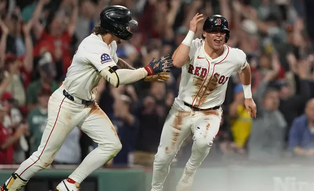 Boston Red Sox Nate Eaton, right, celebrates after scoring the winning run in the tenth inning of a baseball game against the Athletics Wednesday, Sept. 17, 2025, in Boston. (AP Photo/Robert F. Bukaty)